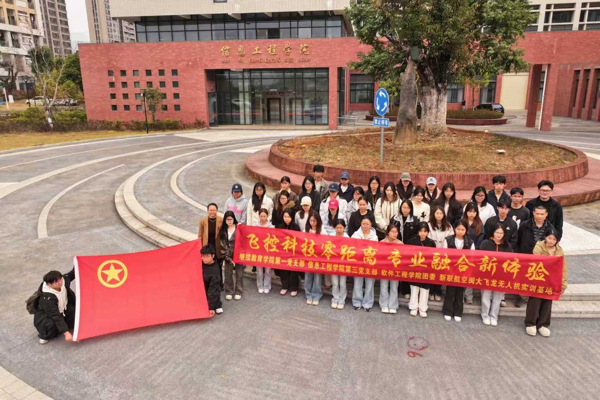 团体培训合影：学员在教学楼前拉着红色横幅合影